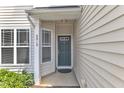 Inviting front entrance with a covered porch and stylish teal-colored front door at 2513 Asher View Ct, Raleigh, NC 27606
