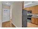 Open kitchen layout with wooden cabinets, stainless steel appliances, and hardwood floors at 2513 Asher View Ct, Raleigh, NC 27606