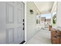 Inviting front porch features a stylish gray door, with view of the home's well-manicured exterior at 2620 Holloway St, Durham, NC 27703