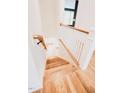 Bright staircase featuring hardwood steps and white railings, leading to the upper level of the home at 2658 Lawndale Ave, Durham, NC 27705