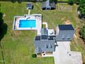 Backyard aerial view featuring a large pool and a solar panel roof at 2709 Les Paul Ln, Apex, NC 27539