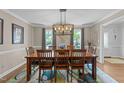 Formal dining room with hardwood floors and views of the outdoor scenery at 2901 Ceremonial Ct, Raleigh, NC 27615