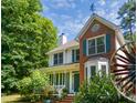 Traditional two-story home with green shutters, brick details, and a cozy front porch at 3137 Falling Cedars Dr, Chapel Hill, NC 27516