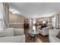 Bright living room featuring hardwood floors, a decorative coffee table, and comfortable seating, great for entertaining at 3359 Marshlane Way Way, Raleigh, NC 27610