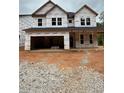 New construction featuring a covered front porch and attached garage, ready for finishing touches at 444 Golden Dragonfly St, Wake Forest, NC 27587