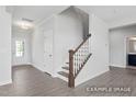 Welcoming foyer featuring luxury vinyl plank flooring, staircase, and entry to living spaces at 444 Golden Dragonfly St, Wake Forest, NC 27587