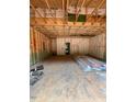 Spacious garage area featuring exposed studs and unfinished ceiling, awaiting customization at 444 Golden Dragonfly St, Wake Forest, NC 27587