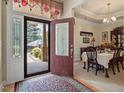 Bright entryway features glass-paneled front door and dining area at 46 Spring Haven Ln, Willow Springs, NC 27592