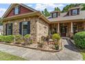 Close up of brick house showing covered front entry and decorative landscaping at 46 Spring Haven Ln, Willow Springs, NC 27592