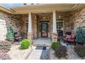 Covered front porch with sitting area at 46 Spring Haven Ln, Willow Springs, NC 27592