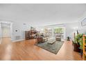 Bright living room features hardwood flooring, a sliding door, and comfortable seating arrangements at 4709 Edwards Mill Rd # H, Raleigh, NC 27612