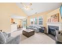 Open living area with neutral carpet, fireplace, adjacent dining area, and a sliding door to the backyard at 5312 Suntan Lake Dr, Raleigh, NC 27610