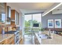 Gourmet kitchen featuring stainless steel appliances, granite countertops, and ample natural light at 601 W Rosemary St # 416, Chapel Hill, NC 27516