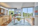 Open floorplan showcasing modern kitchen with eat-in island, adjacent to dining area with large windows at 601 W Rosemary St # 416, Chapel Hill, NC 27516