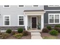 Charming entryway featuring stone accents and a covered porch, offering a welcoming entrance to the home at 6415 Mentor Pl, Raleigh, NC 27616