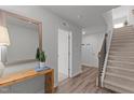 Inviting foyer with wood-look floors, staircase, and stylish decor, creating a warm and welcoming atmosphere at 6415 Mentor Pl, Raleigh, NC 27616
