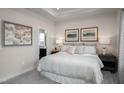 Serene bedroom boasts tray ceiling, soft lighting, neutral tones, and ensuite bathroom at 700 Tambor Rd, Durham, NC 27713