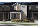Charming townhome exterior with well-maintained landscaping and covered porch at 717 Chandler Stone Dr, Zebulon, NC 27597