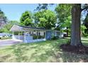 Charming single-story home featuring a carport, a well-maintained lawn, and a mature tree at 722 Orchard Dr, Graham, NC 27253