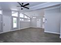 Spacious living room featuring vaulted ceilings, gray flooring, and natural light from multiple windows at 722 Orchard Dr, Graham, NC 27253