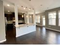 Open-concept living space with hardwood floors seamlessly connecting the kitchen at 7241 Terregles Dr, Raleigh, NC 27617