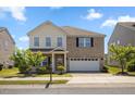 Charming two-story home featuring a brick facade, two-car garage, and well-maintained landscaping at 833 Ember Dr, Durham, NC 27703