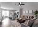 Open-concept living room showcasing kitchen with stainless steel appliances and spacious seating area at 874 John St, Clayton, NC 27520