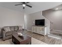 Comfortable living room featuring modern furnishings and stairs to the next level at 874 John St, Clayton, NC 27520