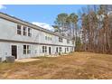 Backyard view shows patio and grass area perfect for outdoor activities and entertaining at 878 John St, Clayton, NC 27520