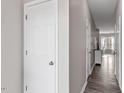 Inviting hallway with wood-look flooring, leading to the main living area and other rooms at 878 John St, Clayton, NC 27520