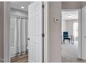 Hallway featuring white doors adjacent to the bathroom and bedroom with light-colored walls at 882 John St, Clayton, NC 27520