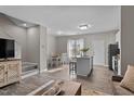 Open-concept living space featuring a kitchen island, dining area, and cozy seating at 882 John St, Clayton, NC 27520