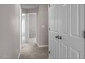 Hallway featuring neutral paint and carpet with white doors leading to various rooms at 886 John St, Clayton, NC 27520