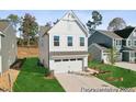 New construction home showcasing a white facade and two-car garage at 92 Horseshoe Pl # 9, Angier, NC 27501