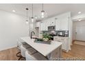 Modern kitchen features an island with pendant lighting, sleek countertops, and stainless steel appliances at 92 Horseshoe Pl # 9, Angier, NC 27501