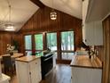 Bright kitchen features butcher block countertops, stainless appliances, and ample natural light at 102 Pebble Ct, Chapel Hill, NC 27516