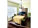 Bright dining area featuring a chandelier and views of the backyard through a large window at 104 Fox Trail Ln, Morrisville, NC 27560