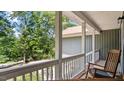 Inviting front porch with a rocking chair, offering a relaxing outdoor space at 106 Nations Cove, Louisburg, NC 27549