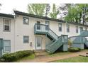 Apartment building featuring painted siding, green trim, and stairs to the second level at 107 Ashley Forest Rd # B, Chapel Hill, NC 27514