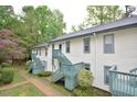 Apartment building featuring painted siding, green trim, and stairs to the second level at 107 Ashley Forest Rd # B, Chapel Hill, NC 27514