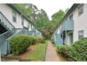 Exterior view of condo buildings with well maintained landscaping and stairs to upper units at 107 Ashley Forest Rd # B, Chapel Hill, NC 27514