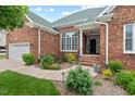 Inviting brick home featuring a well-manicured lawn and a covered front porch at 107 Regiment Way, Durham, NC 27705