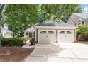 Charming home featuring a detached two-car garage, complemented by lush greenery and a well-maintained driveway at 108 Ripplewater Ln, Cary, NC 27518