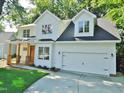 Charming two-story home featuring a covered porch, a two-car garage, and a driveway at 1104 Barrow Nook Ct, Apex, NC 27502