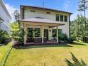 Spacious covered back patio with outdoor furniture, surrounded by a lush green lawn at 111 Chapel Run Way, Chapel Hill, NC 27517