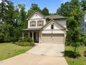Attractive two-story home with a two-car garage, a well-maintained lawn, and lush landscaping at 111 Chapel Run Way, Chapel Hill, NC 27517