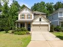 Inviting two-story home with a two-car garage, manicured lawn, and charming curb appeal at 111 Chapel Run Way, Chapel Hill, NC 27517