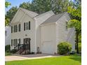 Charming two-story home with an attached garage and a well-maintained lawn at 112 Fairford Dr, Holly Springs, NC 27540