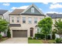 Inviting two-story home with a brick facade, a two-car garage, and mature landscaping at 113 Mazarin Ln, Cary, NC 27519