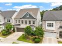 Attractive two-story home with light brick, two-car garage, and professionally landscaped yard at 113 Mazarin Ln, Cary, NC 27519